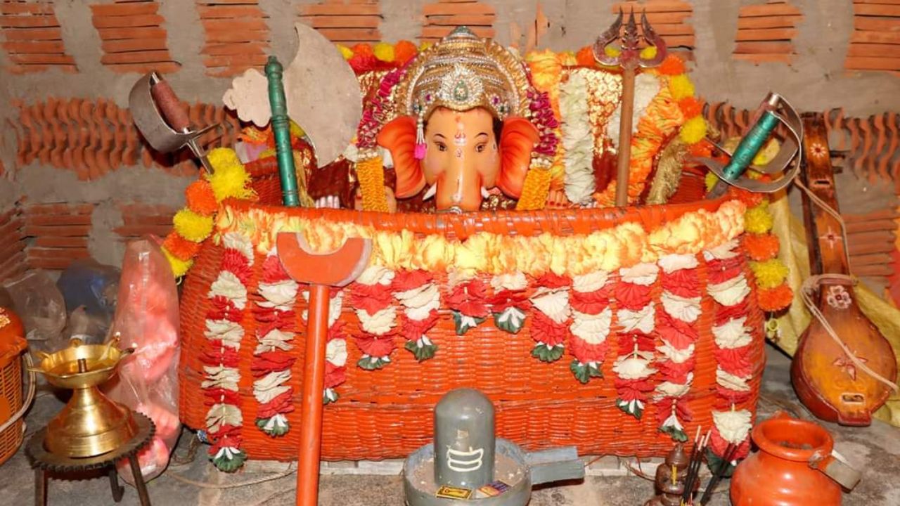 an orange and yellow decorated Dashavtar Petara with Lord Ganesh Mukhavta in it.